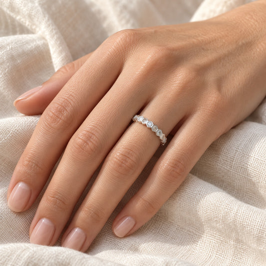 The Hexagon Moissanite Eternity Band worn by a model in natural daylight