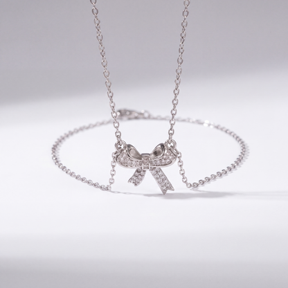 The Bow Necklace by JUSMIR, bow pendant necklace with clear stones, studio product photo