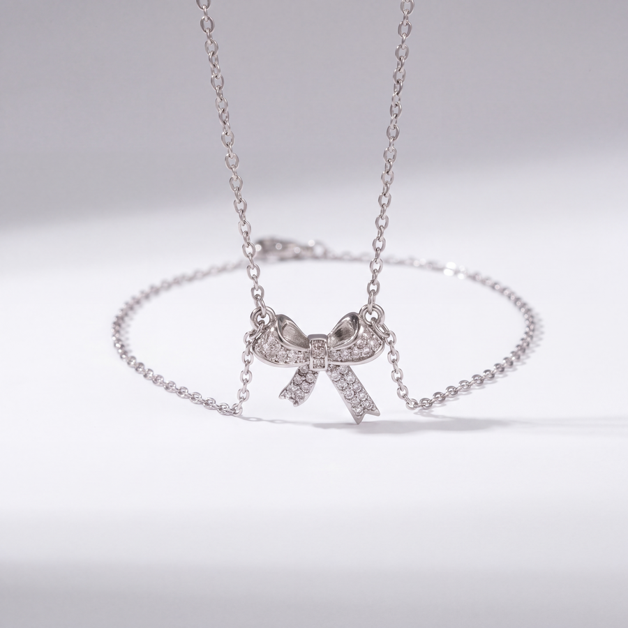 The Bow Necklace by JUSMIR, bow pendant necklace with clear stones, studio product photo