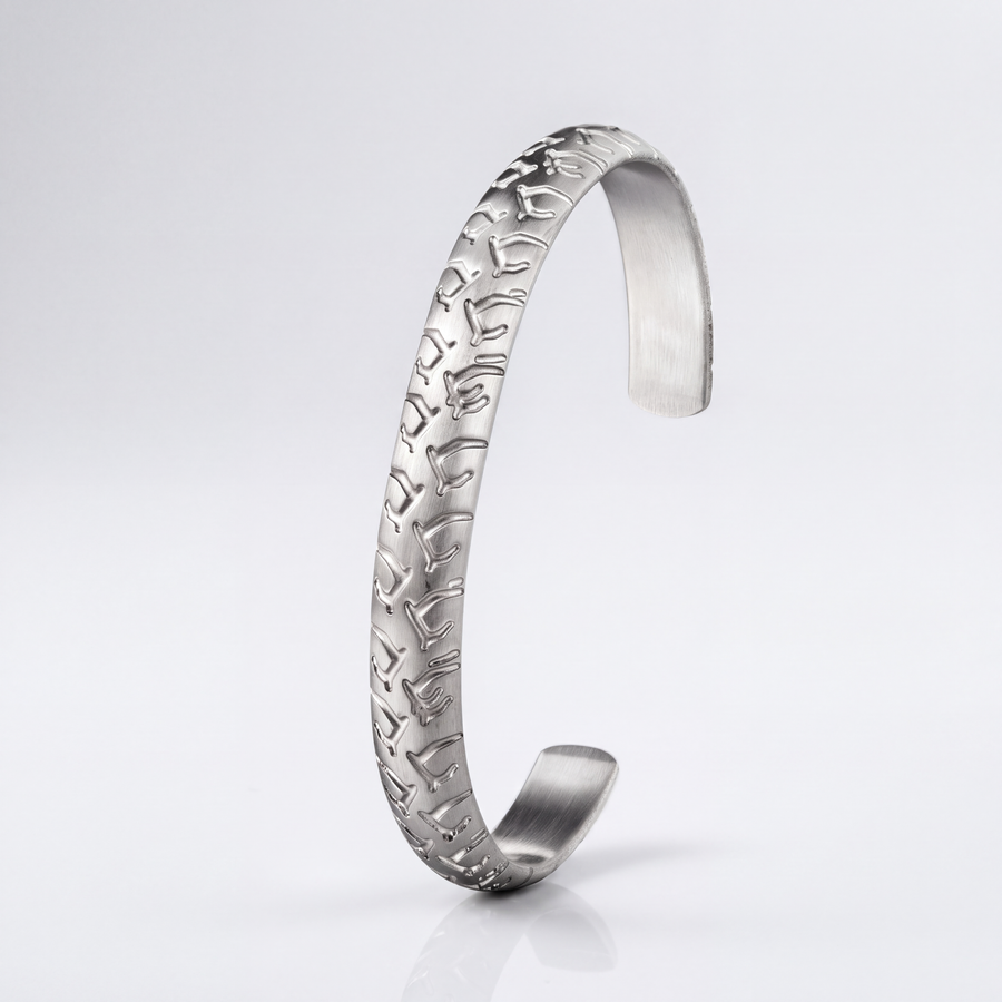 The Tread Cuff by JUSMIR, engraved stainless steel open cuff, studio product photo