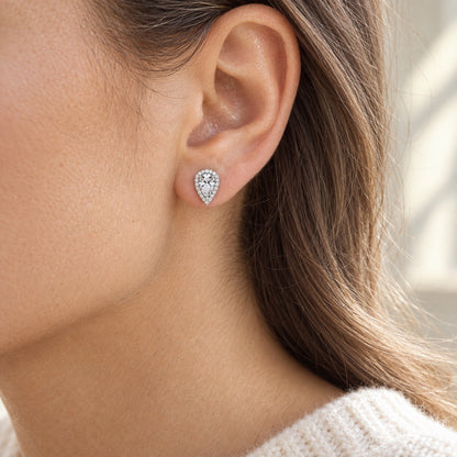The Pear Halo Moissanite Studs worn by a model in natural daylight