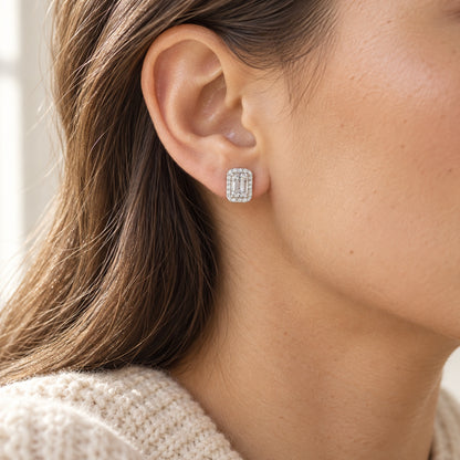 The Emerald Halo Moissanite Studs worn by a model in natural daylight