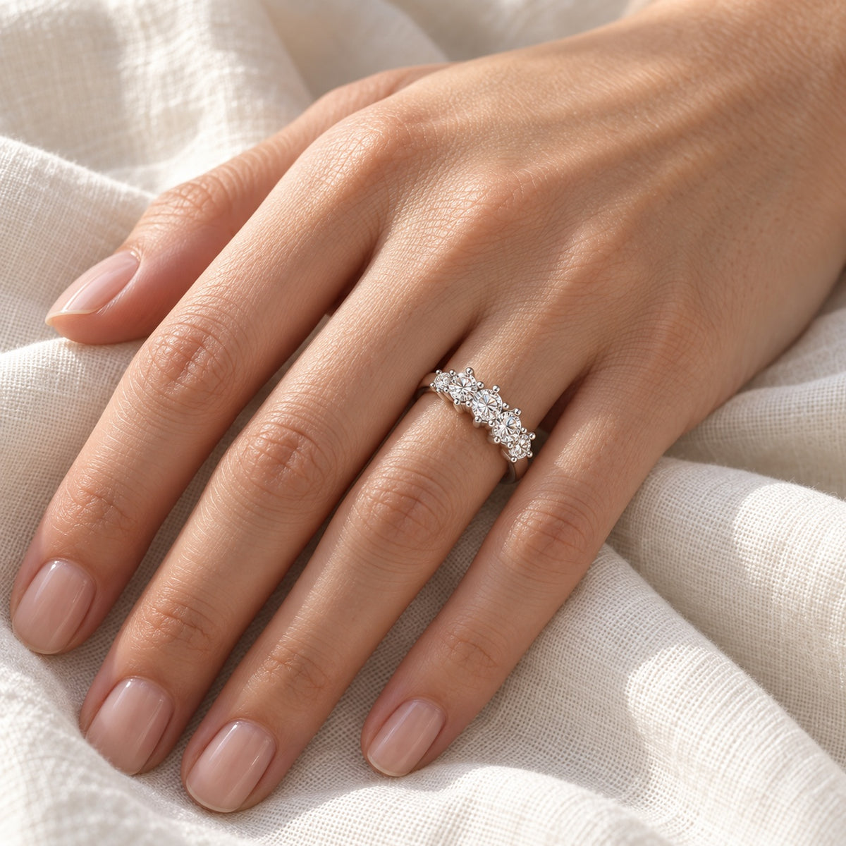 The Five-Stone Moissanite Ring worn by a model in natural daylight
