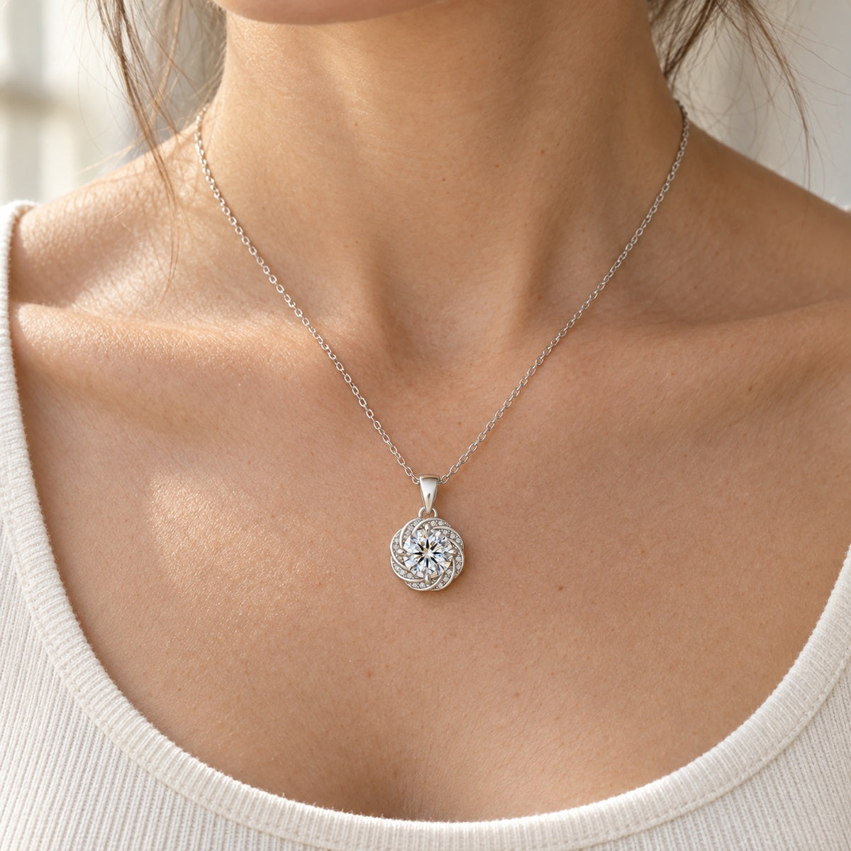 The Swirl Moissanite Necklace worn by a model in natural daylight