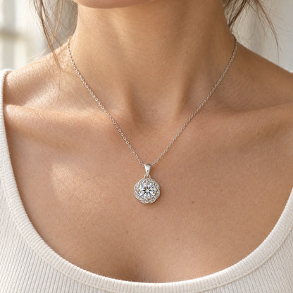 The Swirl Moissanite Necklace worn by a model in natural daylight