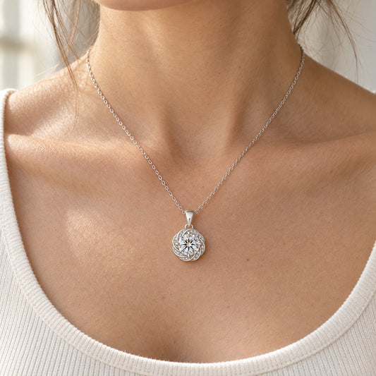 The Swirl Moissanite Necklace worn by a model in natural daylight