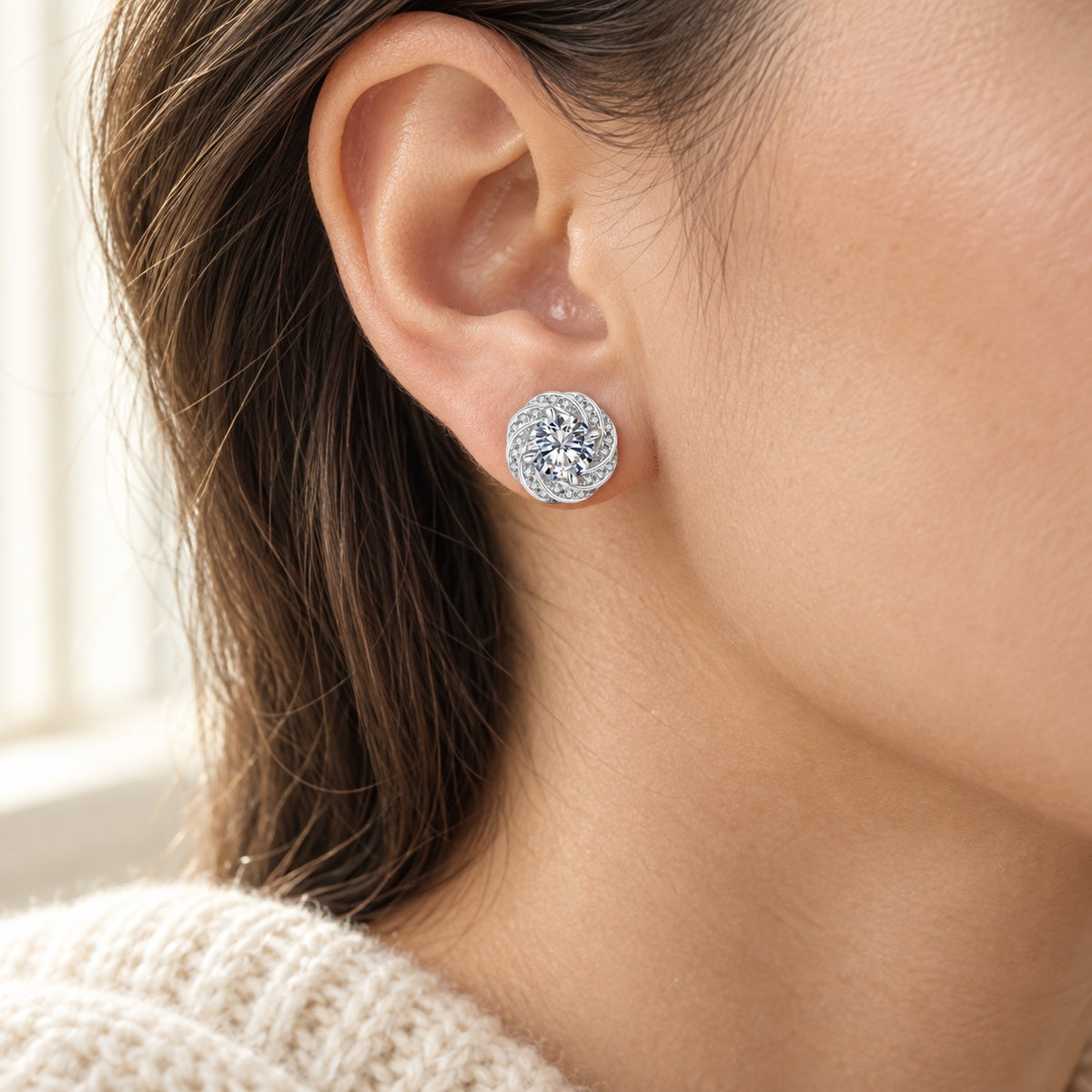 The Swirl Moissanite Studs worn by a model in natural daylight