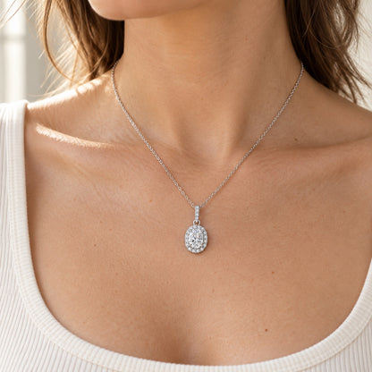 The Oval Halo Moissanite Necklace worn by a model in natural daylight