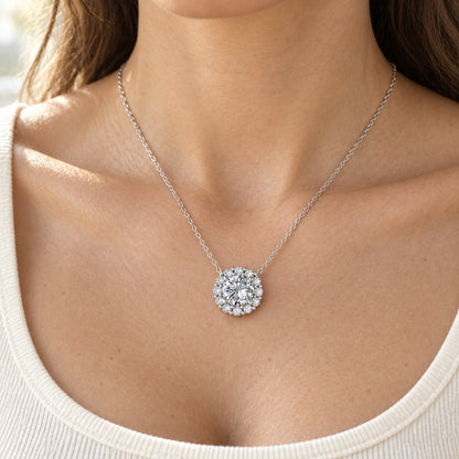 The Flower Halo Moissanite Necklace worn by a model in natural daylight, shown with the 8 mm (2 ct) centre
