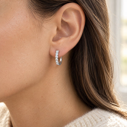 The Moissanite Hoops worn by a model in natural daylight, shown in the 13 mm size, white gold tone