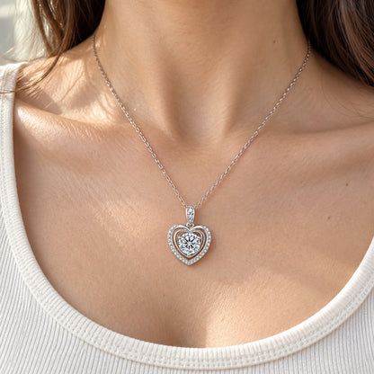 The Heart Moissanite Necklace worn by a model in natural daylight, shown with the 6.5 mm (1 ct) centre