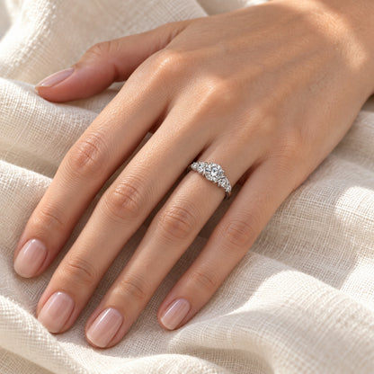 The Three-Stone Moissanite Ring worn by a model in natural daylight