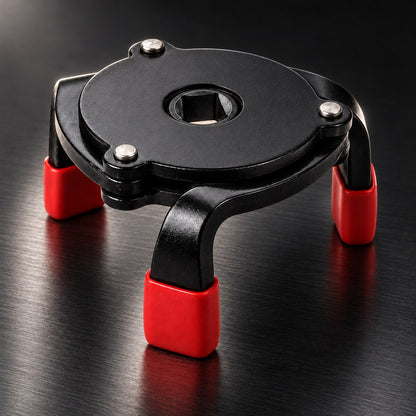 3-jaw oil filter wrench on a dark workshop surface