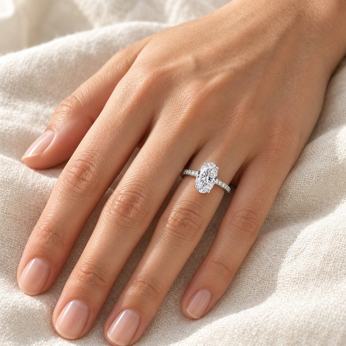 The Oval Moissanite Ring worn by a model in natural daylight, 7 × 9 mm oval centre stone