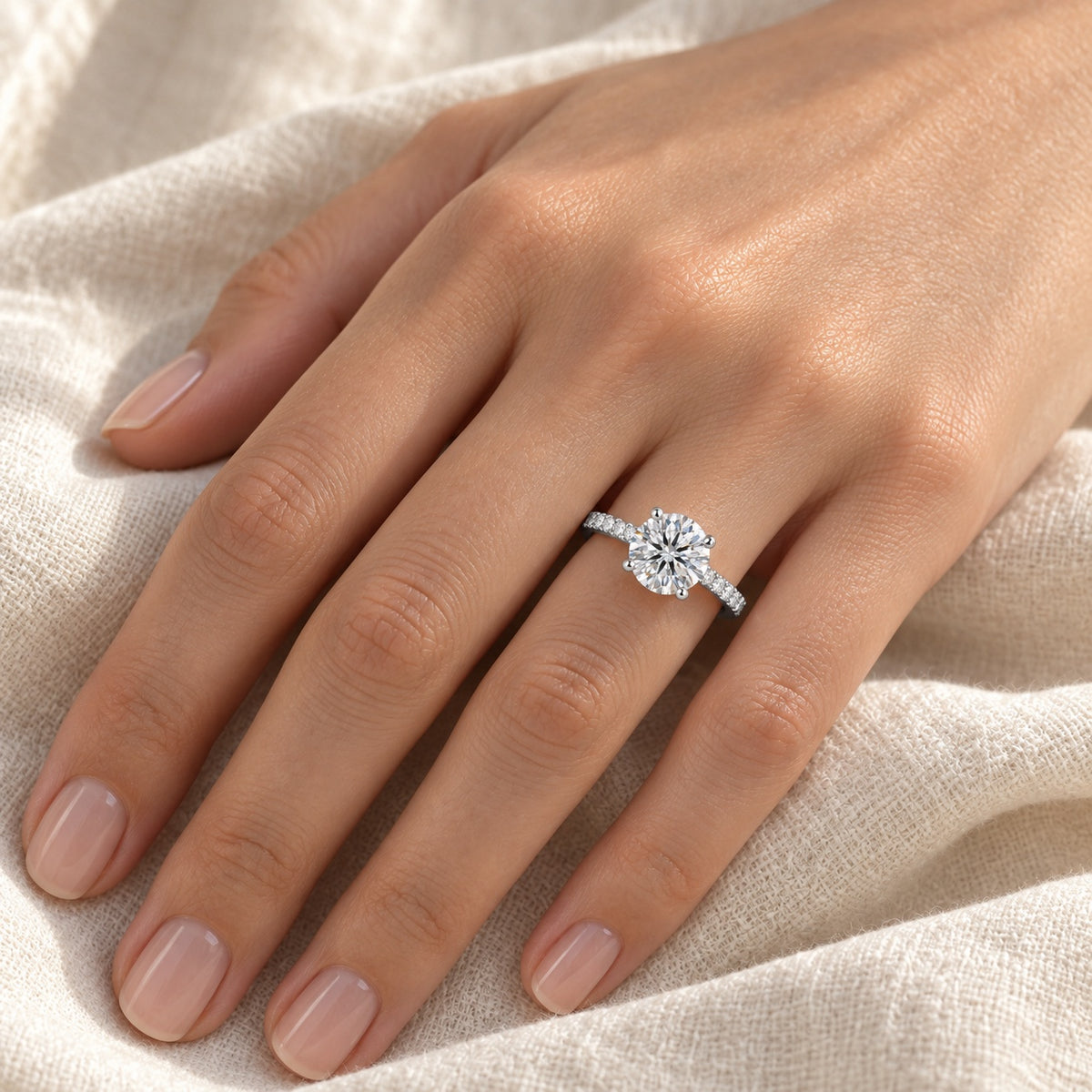 The Round Moissanite Ring worn by a model in natural daylight, shown with the 8 mm (2 ct) centre stone