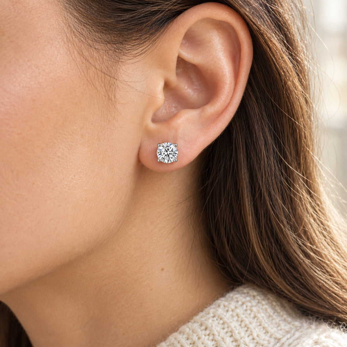 The Solitaire Moissanite Studs worn by a model in natural daylight, shown with a 6 mm stone, white gold plated