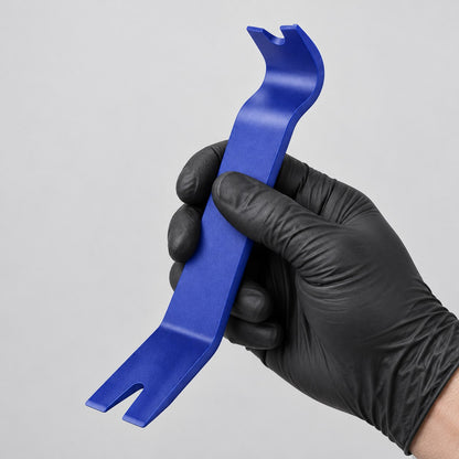 Trim removal tool held in a gloved hand to show its size