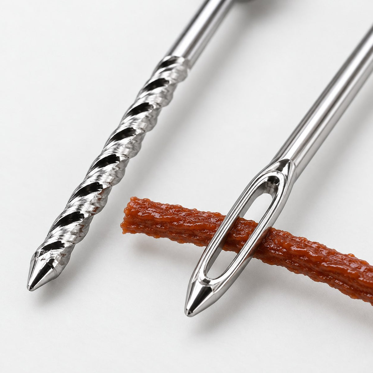 Close-up of the spiral reamer and the insertion needle with a repair strip