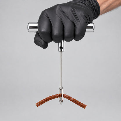 Tyre plug repair kit held in a gloved hand to show its size