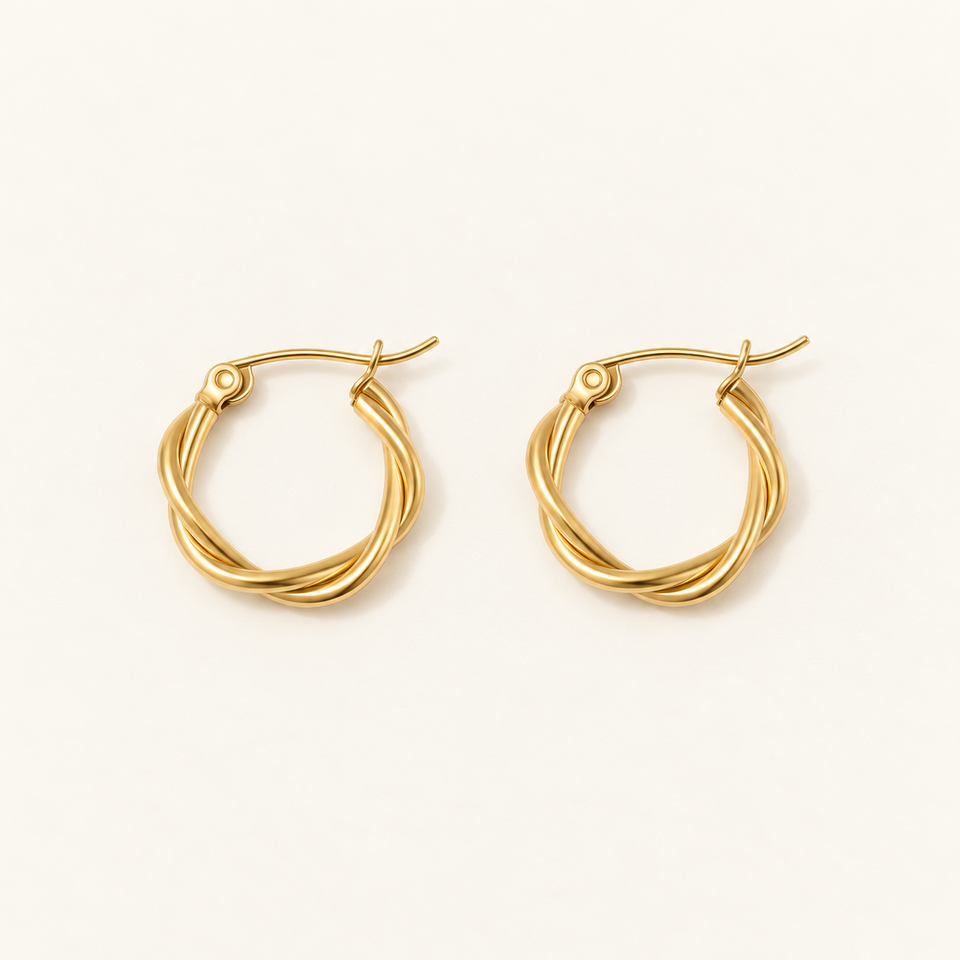 The Twisted Rope Hoops in gold plating on an ivory background