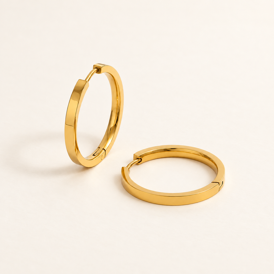 The Polished Hoops in gold plating on an ivory background