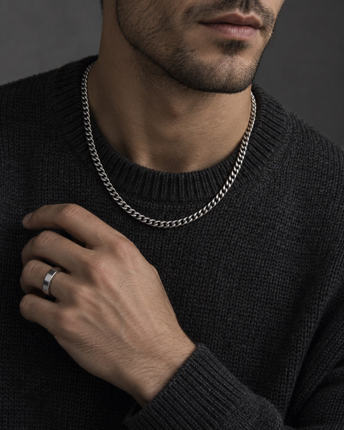 Editorial styling with a silver-tone chain and ring