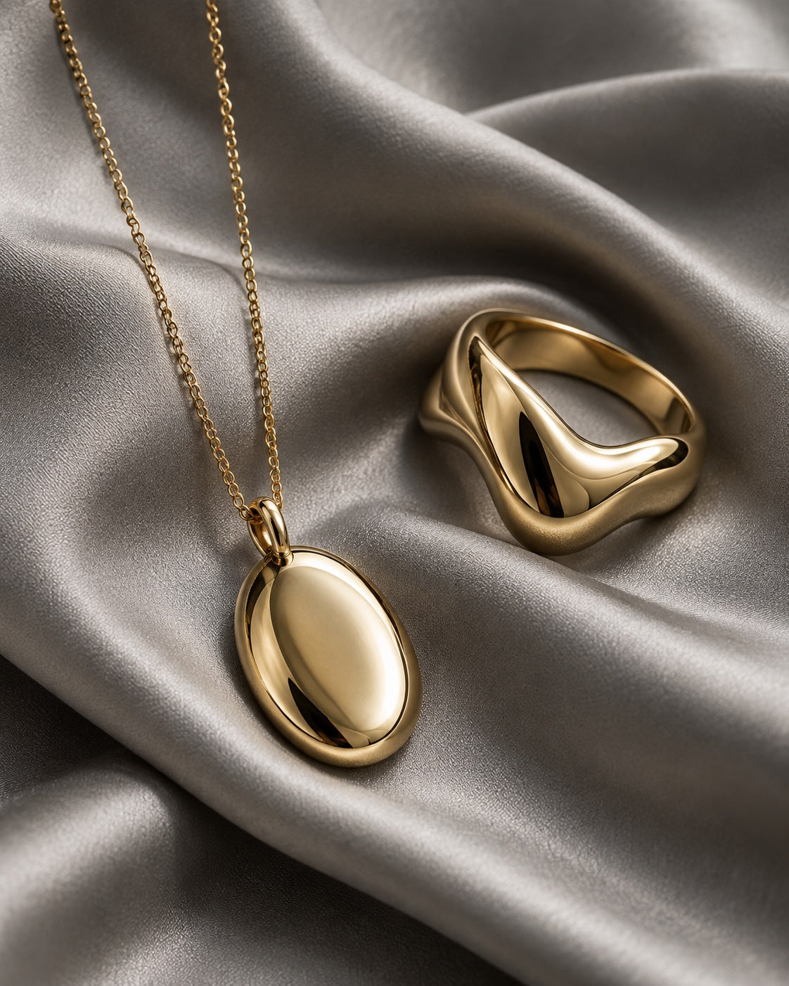 Editorial styling with a gold-tone necklace and ring